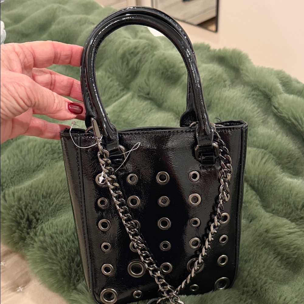 Chic Black patent Eyelet Mini Bag. Top handle and removable crossbody strap.New.